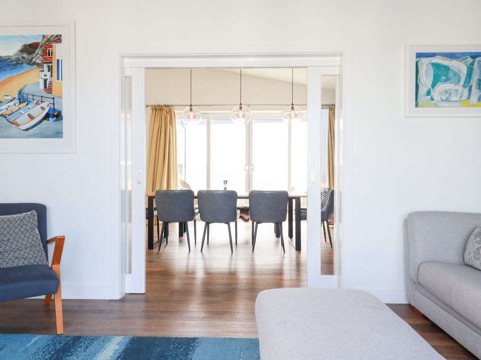 A living room with a sofa and an armchair at Beach Haven in Perranporth