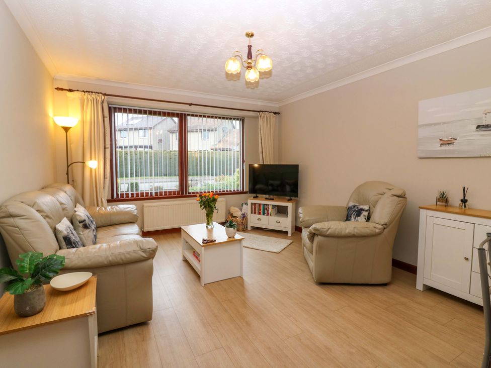 A living room with a television and a coffee table at 48 Edenbank Road Cupar, Fife