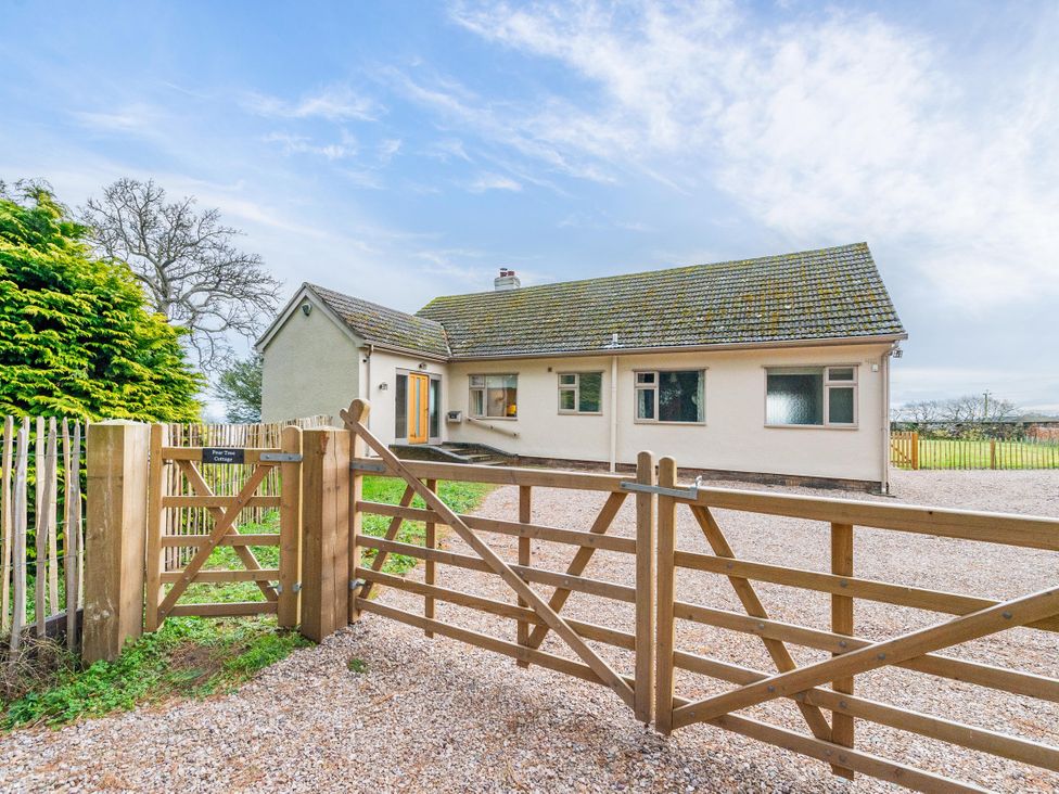 A house with a gate and gravel driveway at Pear Tree Cottage Church Pulverbatch near Dorrington
