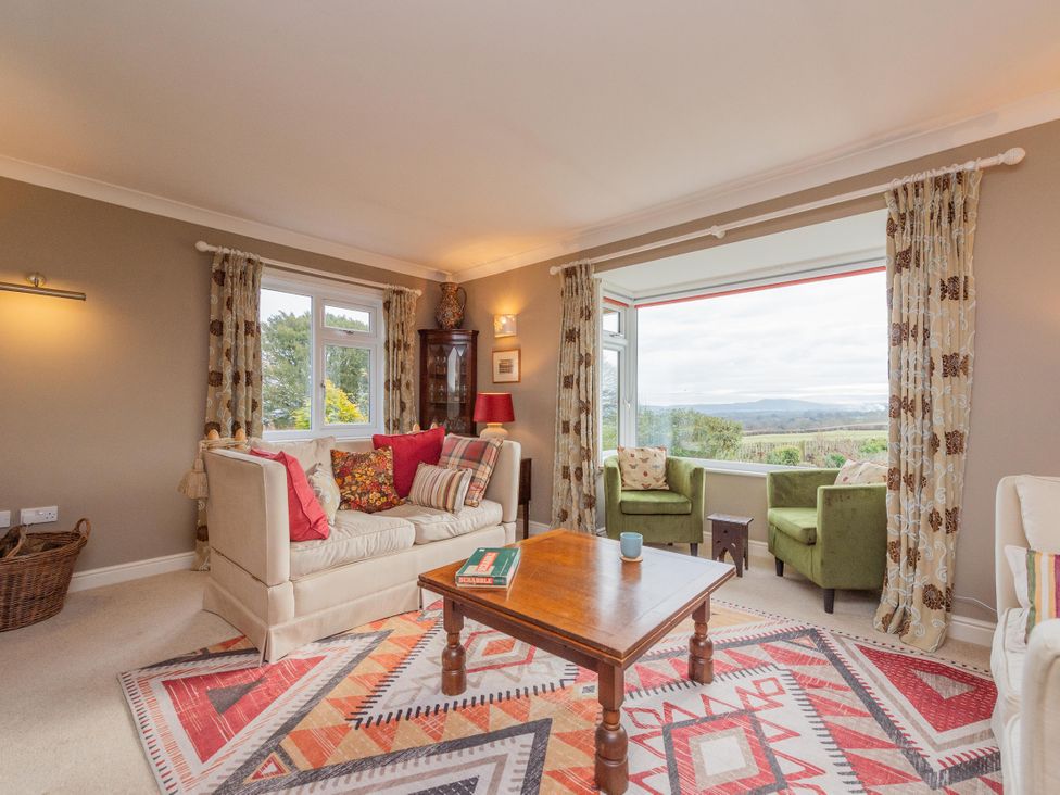 A living room with a sofa and coffee table at Pear Tree Cottage Church Pulverbatch near Dorrington