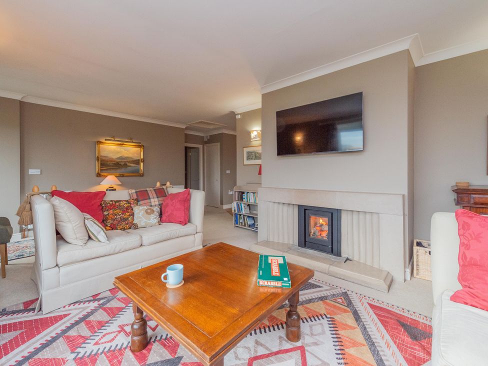 A living room with a sofa and coffee table at Pear Tree Cottage in Church Pulverbatch near Dorrington