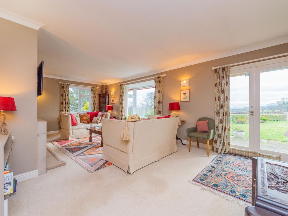 A living room with a sofa and armchair at Pear Tree Cottage in Church Pulverbatch near Dorrington