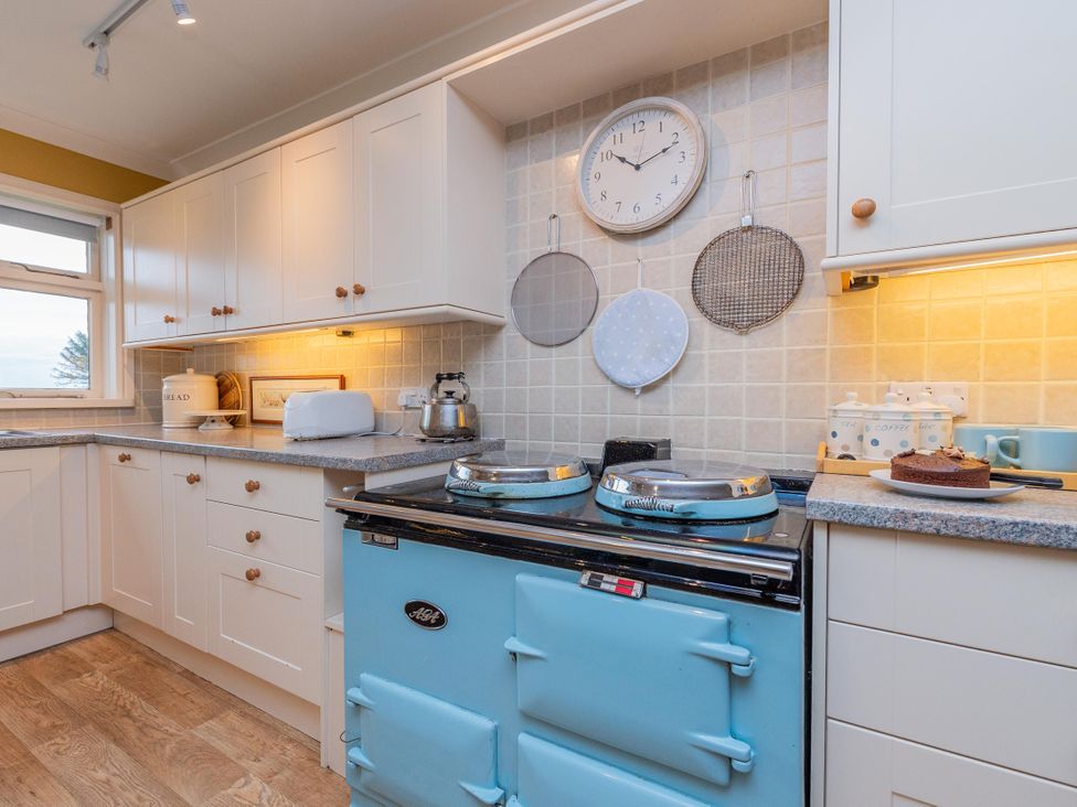 A kitchen with an oven and countertop at Pear Tree Cottage Church Pulverbatch near Dorrington