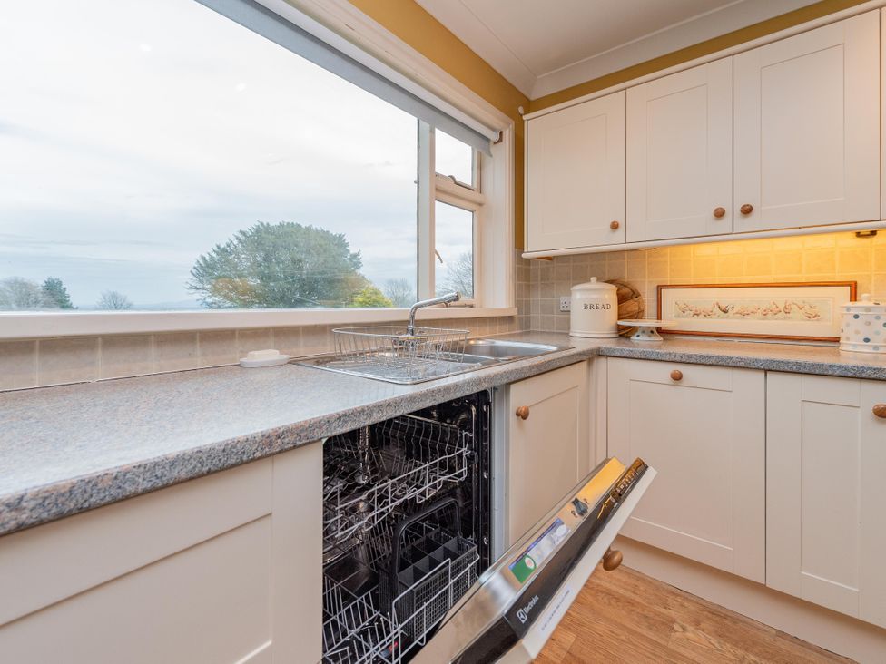 A kitchen with a sink and dishwasher at Pear Tree Cottage Church Pulverbatch near Dorrington