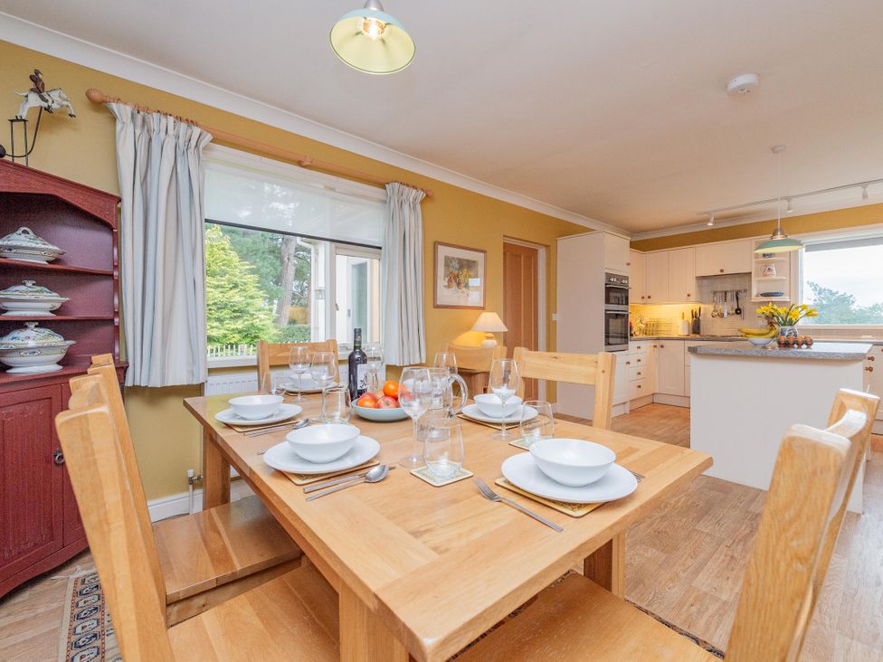 A dining room with a table set for meals at Pear Tree Cottage near Church Pulverbatch
