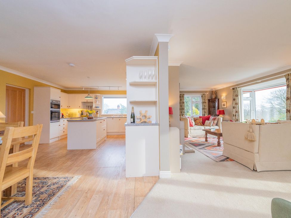 A kitchen with an island and a living room area at Pear Tree Cottage Church Pulverbatch near Dorrington