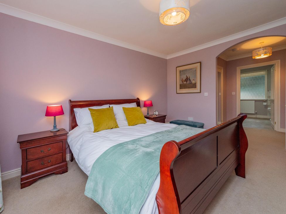 A bedroom with a bed and nightstands at Pear Tree Cottage in Church Pulverbatch near Dorrington