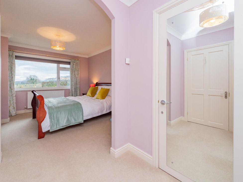 A bedroom with a bed and window at Pear Tree Cottage near Church Pulverbatch