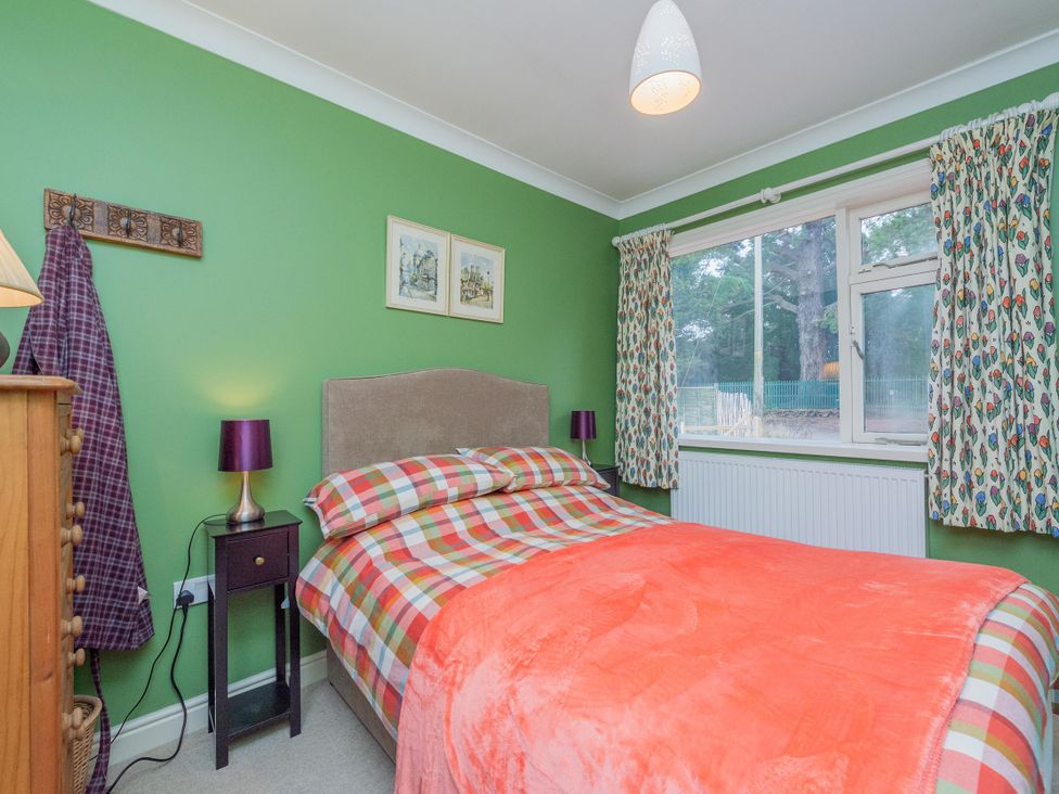 A bedroom with a bed and bedside table at Pear Tree Cottage Church Pulverbatch near Dorrington