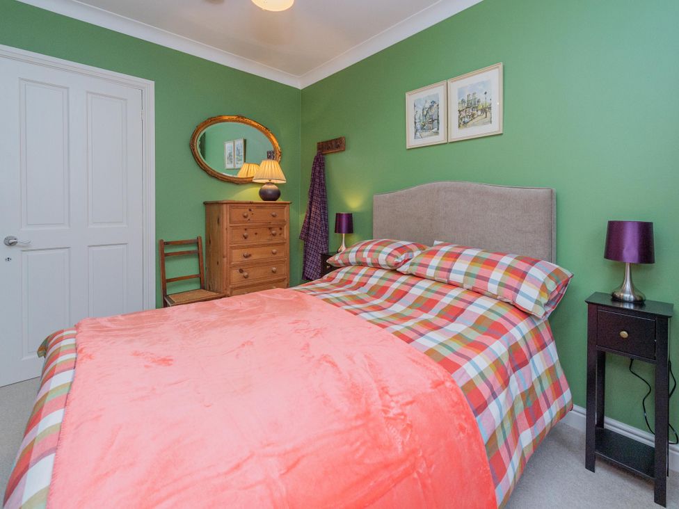 A bedroom with a bed and decorative elements at Pear Tree Cottage Church Pulverbatch near Dorrington