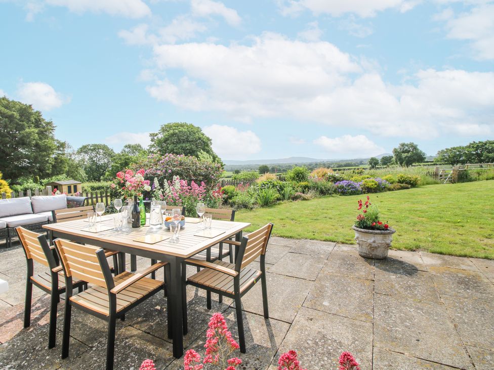 An outdoor seating area with a table and chairs at Pear Tree Cottage Church Pulverbatch near Dorrington