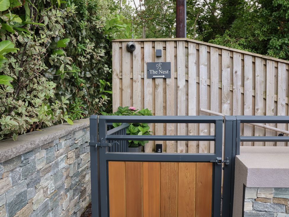 An entrance gate with a sign at The Nest in Prestatyn