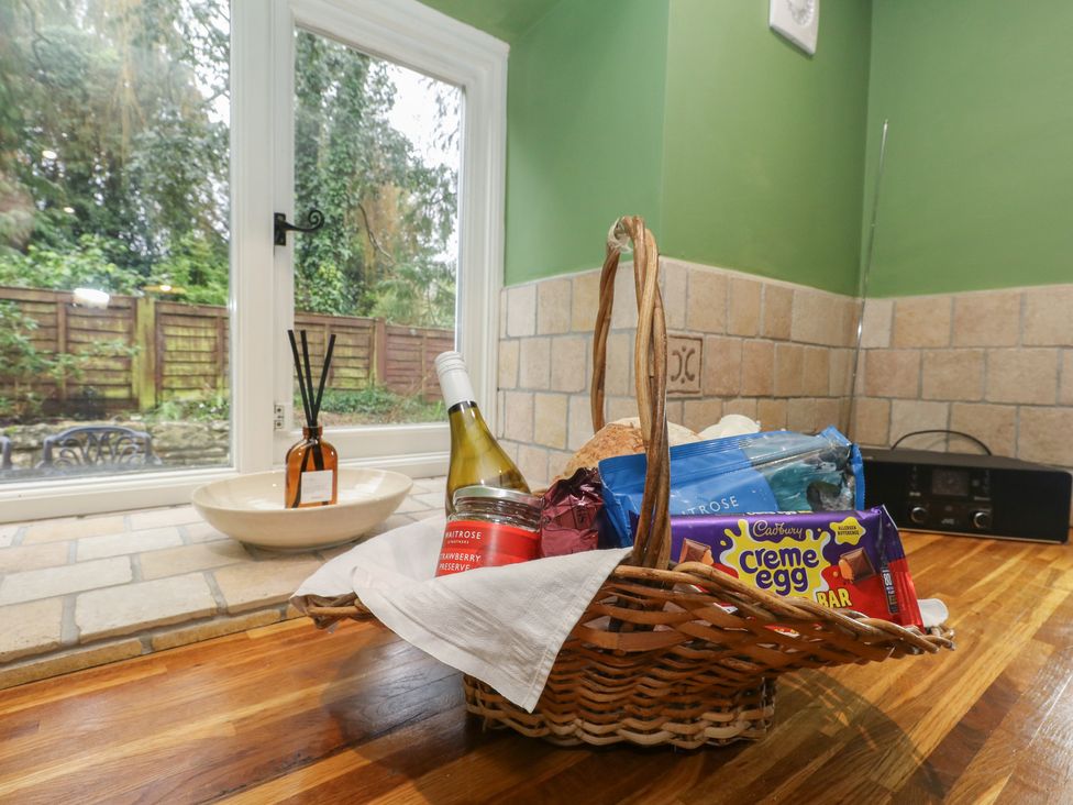 A kitchen with a basket of food items on the countertop at The Grain Store in Weymouth