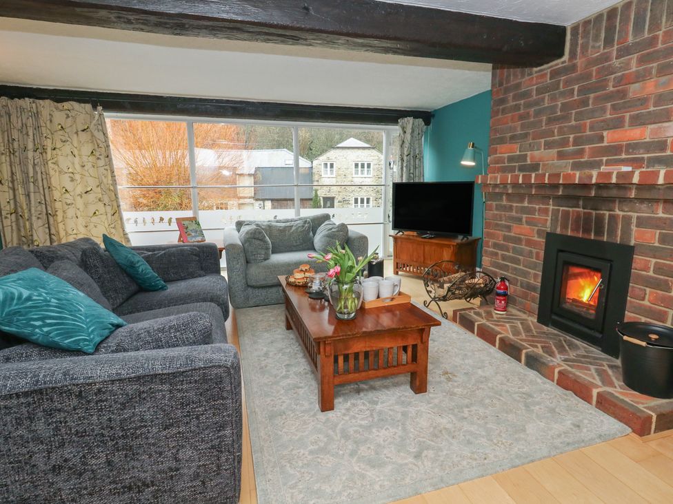 A living room with a television and a fireplace at The Grain Store in Weymouth