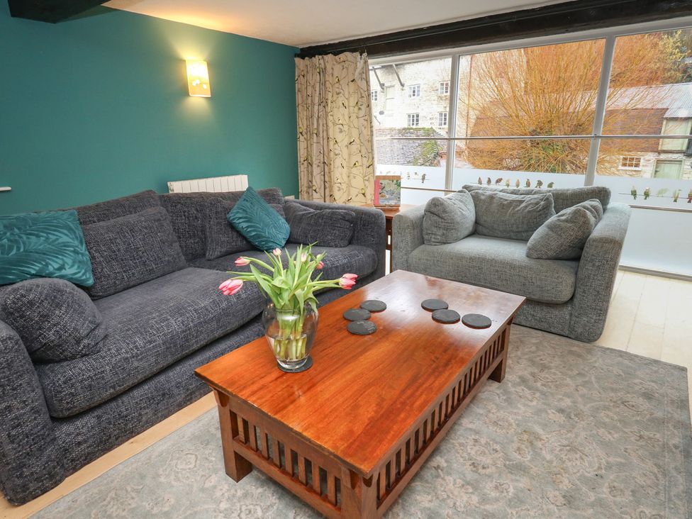 A living room with a sofa and a coffee table at The Grain Store in Weymouth