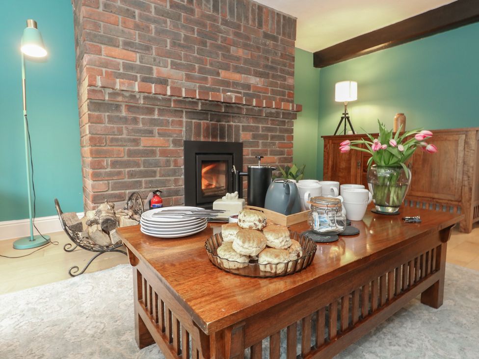 A living room with a fireplace and coffee table at The Grain Store in Weymouth