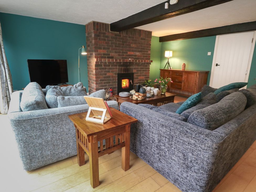 A living room with a sofa and a fireplace at The Grain Store in Weymouth