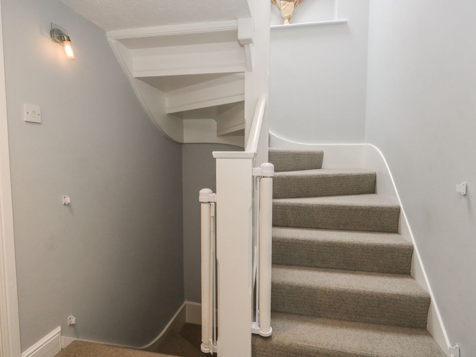 A staircase with carpet and handrail at The Grain Store in Weymouth