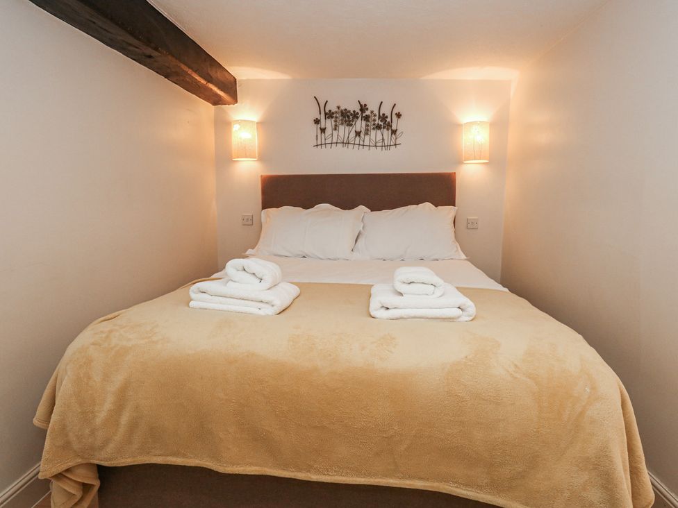 A bedroom with a bed and towels on it at The Grain Store in Weymouth