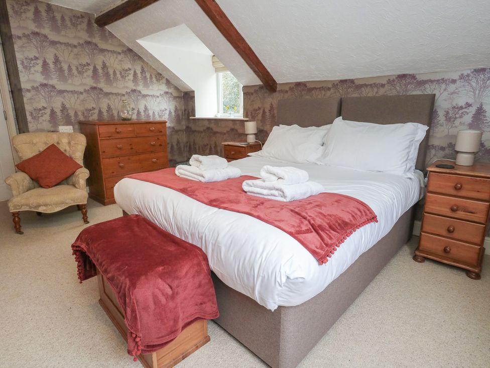A bedroom with a bed and furniture at The Grain Store in Weymouth
