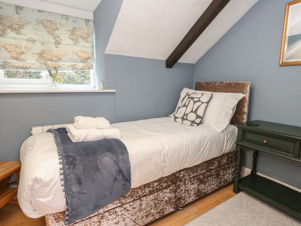 A bedroom with a single bed and a bedside table at The Grain Store in Weymouth
