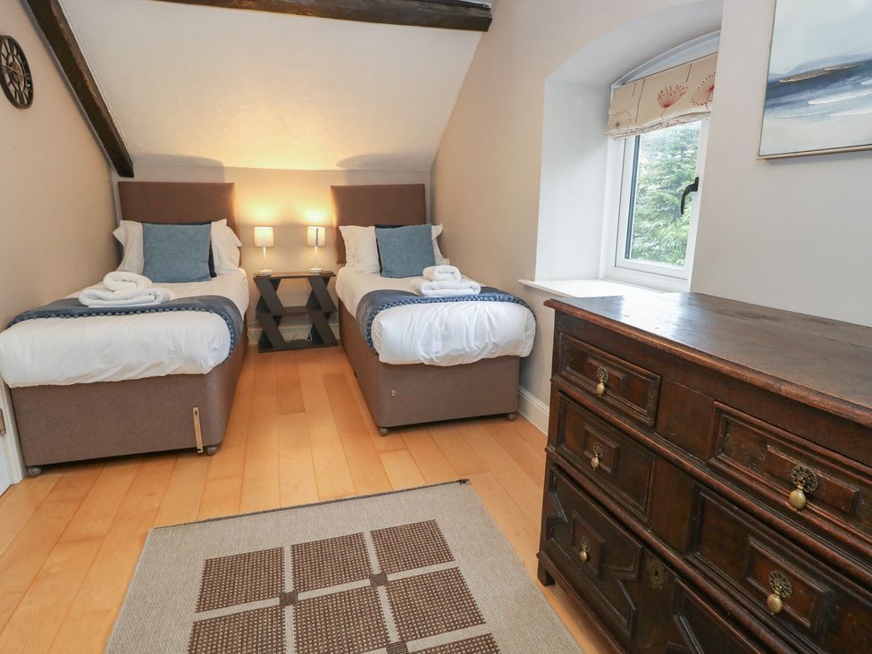 A bedroom with two beds and a dresser at The Grain Store in Weymouth