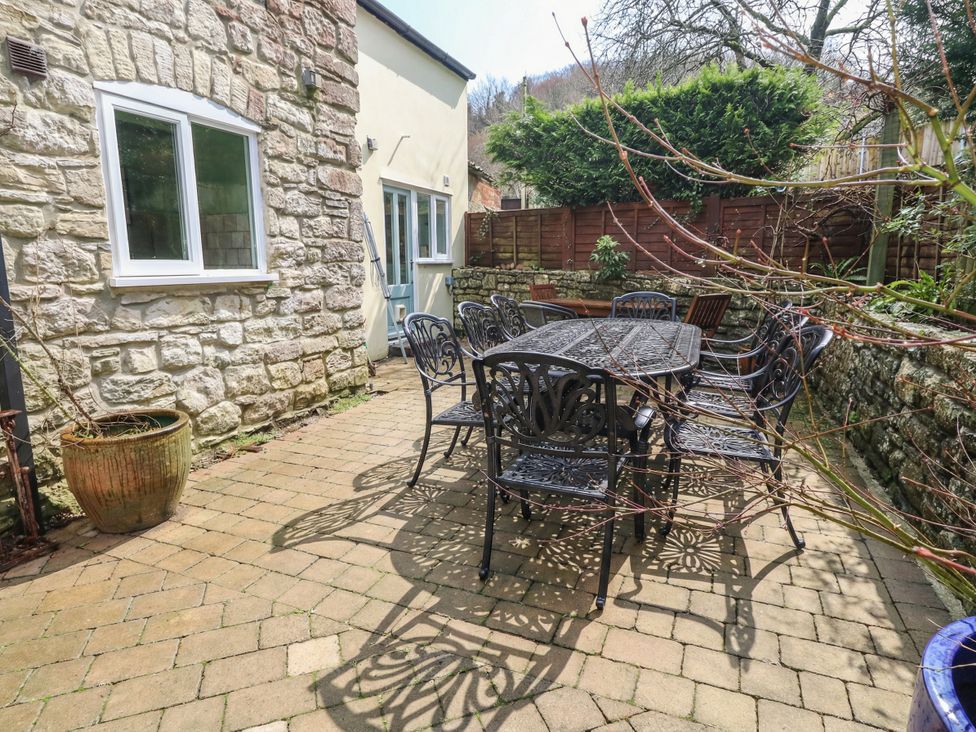 An outdoor patio with a table and chairs at The Grain Store in Weymouth