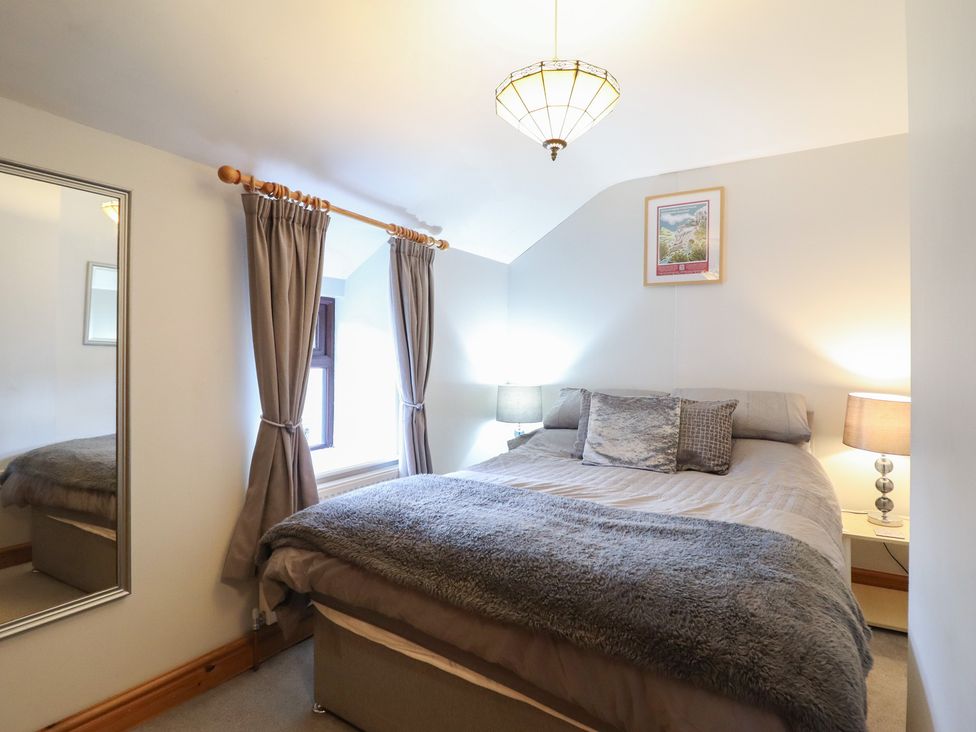 A bedroom with a bed and lamps at Bridgeway House in Blaenau Ffestiniog