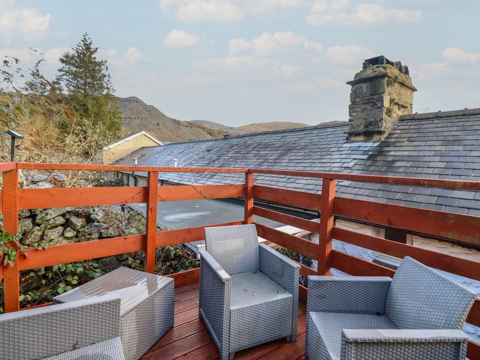 An outdoor area with chairs and a view at Bridgeway House in Blaenau Ffestiniog
