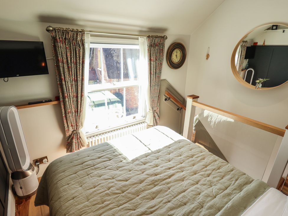 A bedroom with a bed and television at Hangmans cottage in Horncastle