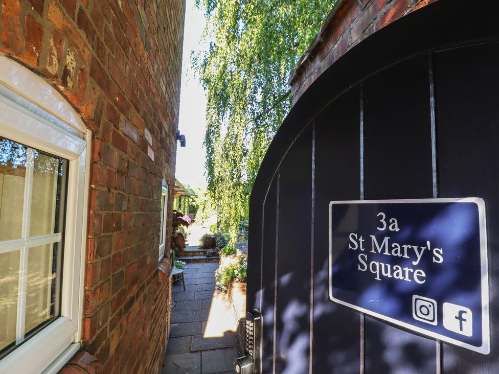 An entrance gate at 3a St Mary's Square with a pathway and plants