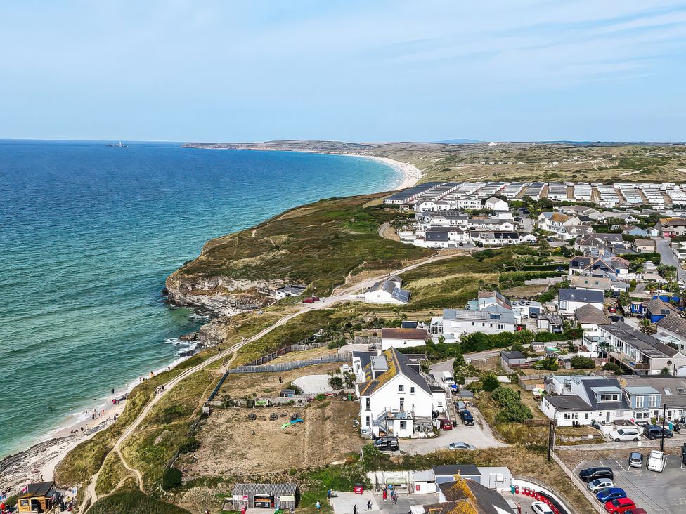 A coastal view with ocean and buildings at The Sandbox in Hayle