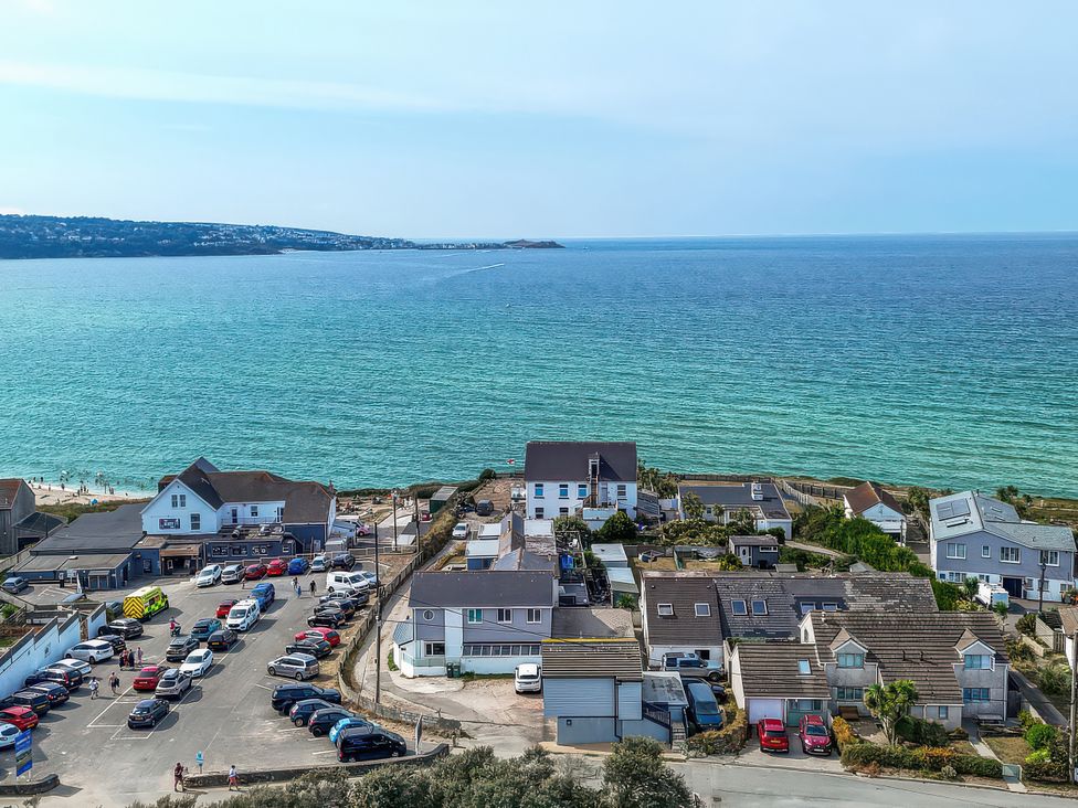 A view of buildings and cars near the sea at The Sandbox in Hayle