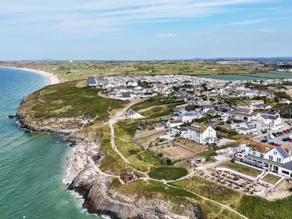 An aerial view of a coastal area with houses and beach at The Sandbox in Hayle