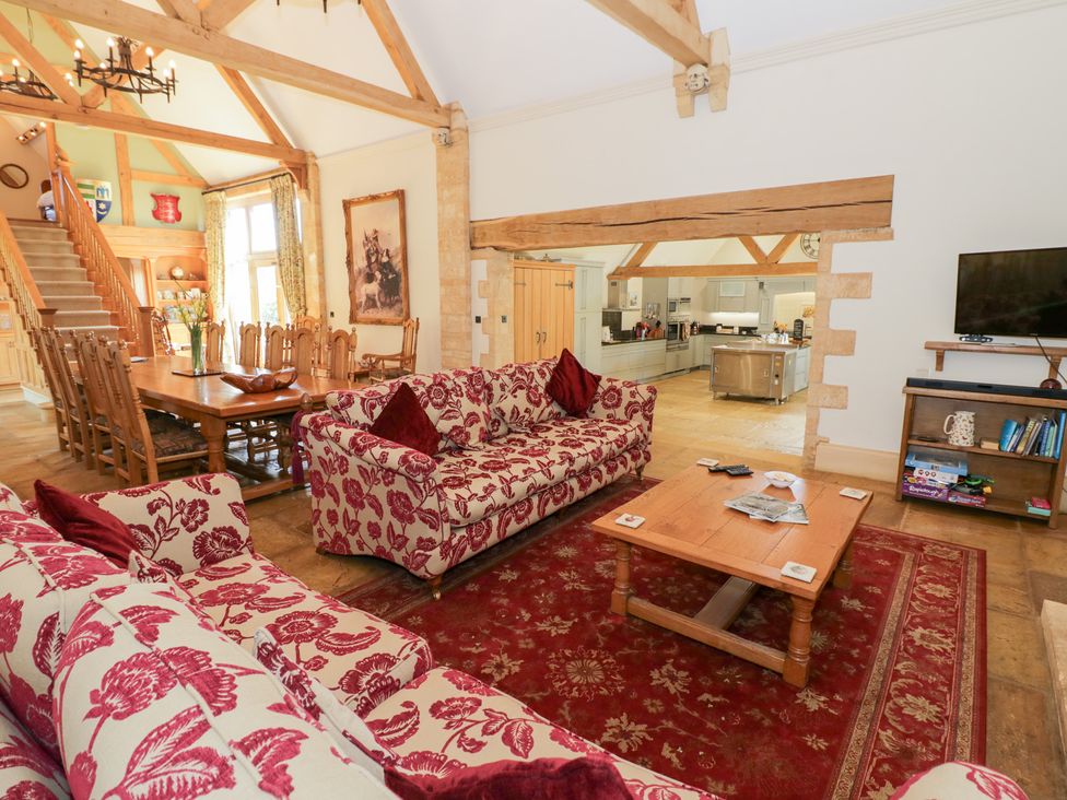 A living room with a sofa, coffee table, and dining area at Rookery Hall in Middle Hill near Broadway