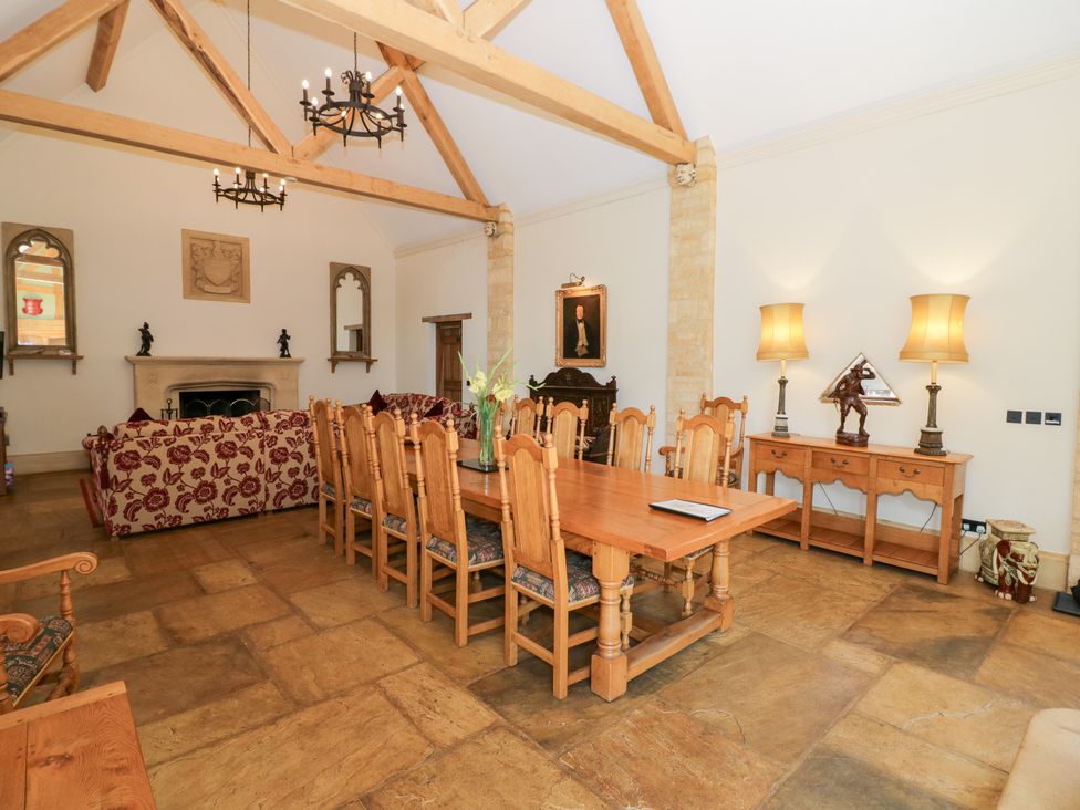 A dining room with a long table and chairs at Rookery Hall in Middle Hill near Broadway