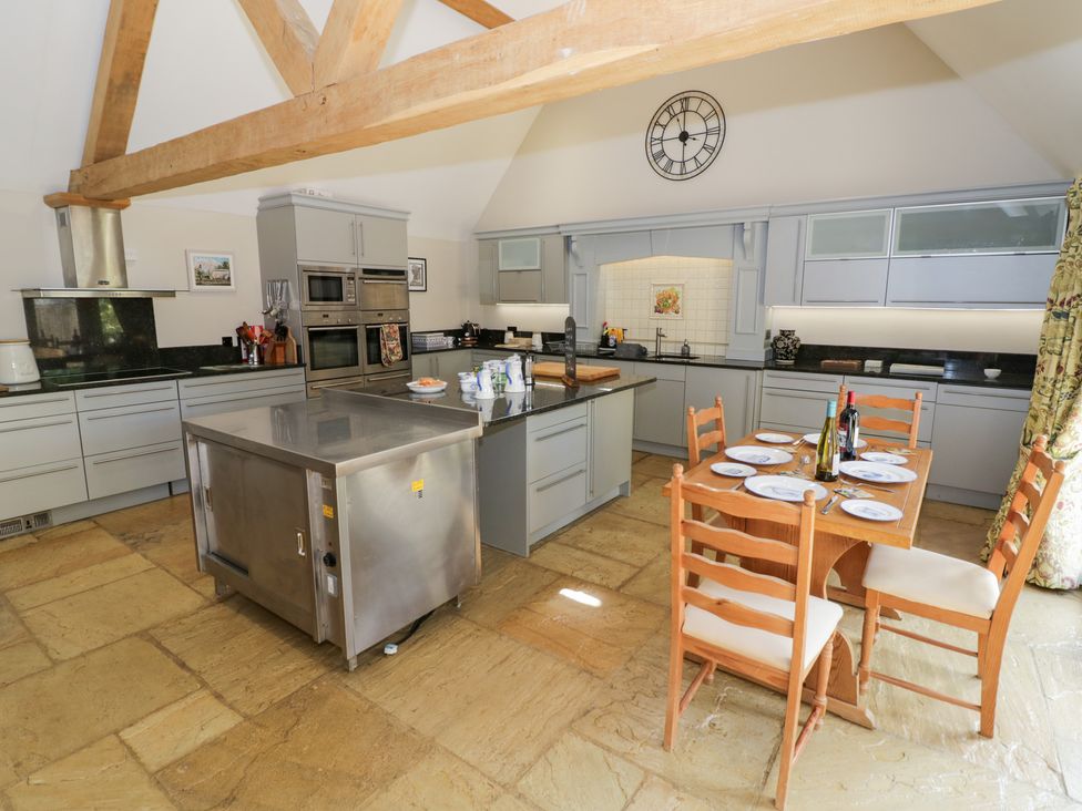 A kitchen with a table and chairs at Rookery Hall in Middle Hill near Broadway