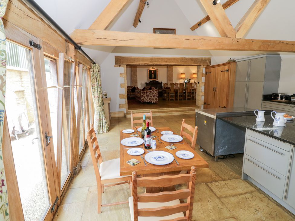 A kitchen with a dining table and chairs at Rookery Hall near Middle Hill