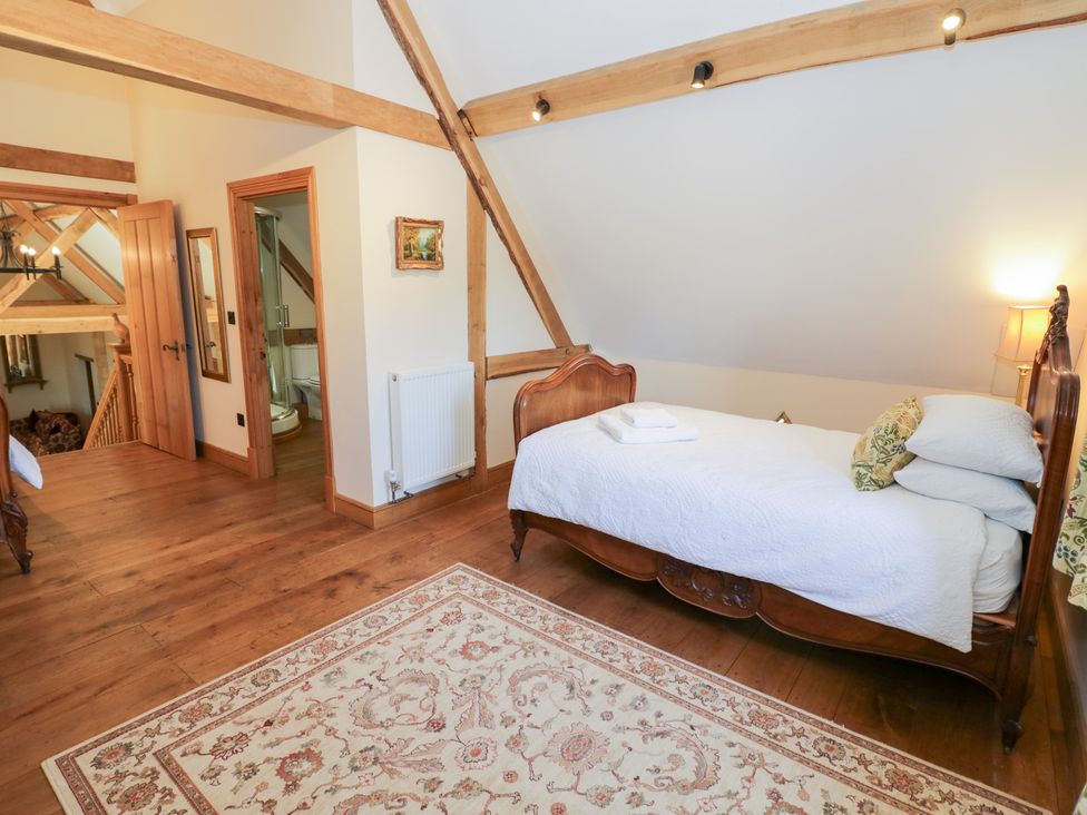 A bedroom with a bed and decor at Rookery Hall in Middle Hill near Broadway