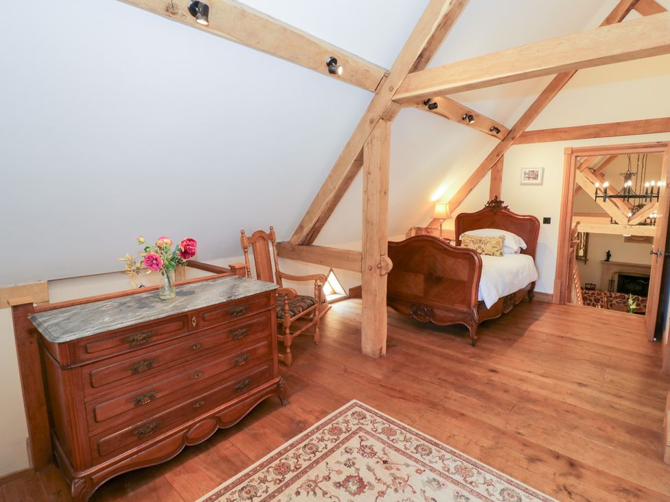 A bedroom with a bed and dresser at Rookery Hall near Middle Hill