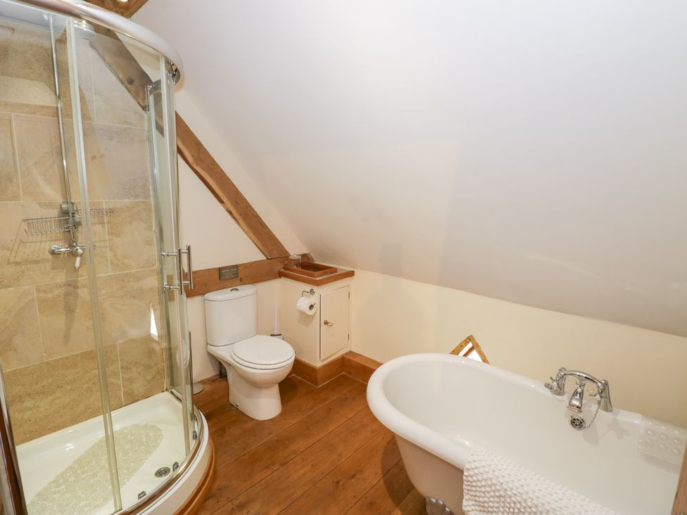 A bathroom with a shower, toilet, and bathtub at Rookery Hall in Middle Hill near Broadway