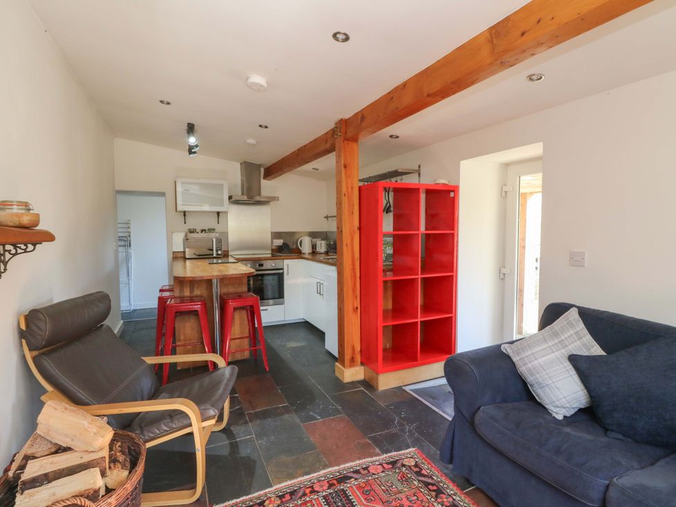 A kitchen with a sofa and a table at Gun Powder Cottage in Tighnabruaich
