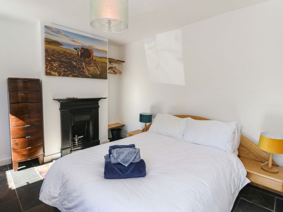 A bedroom with a bed and chest of drawers at Gun Powder Cottage in Tighnabruaich