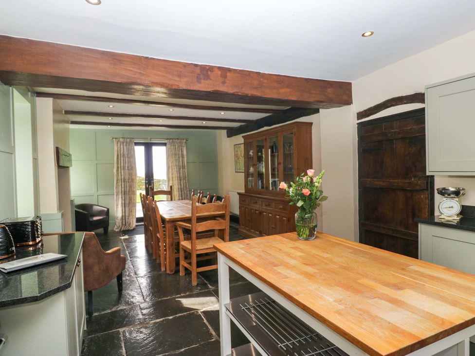 A kitchen with dining furniture and a view at Ewedale Farm in Pennington near Ulverston