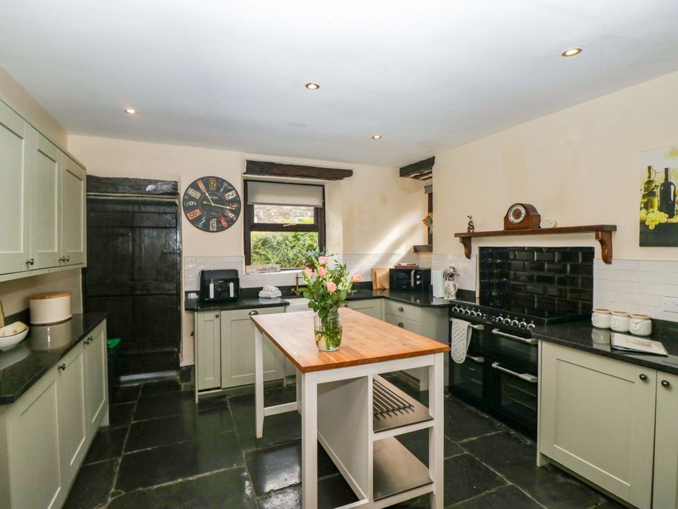A kitchen with cabinets and an island at Ewedale Farm in Pennington near Ulverston