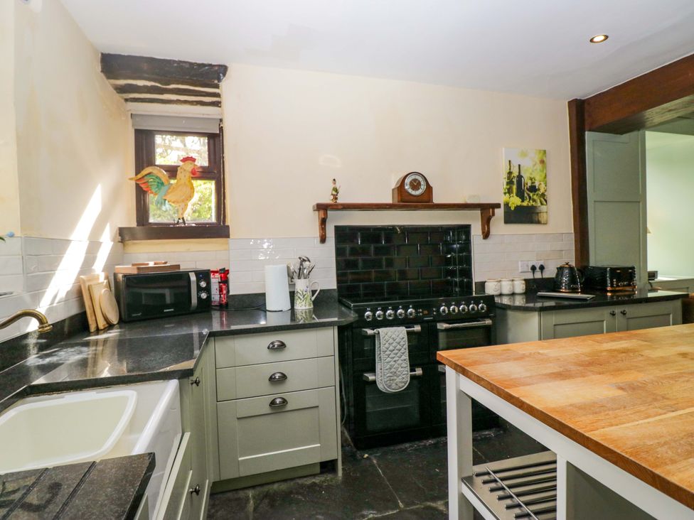 A kitchen with a stove and microwave at Ewedale Farm in Pennington near Ulverston