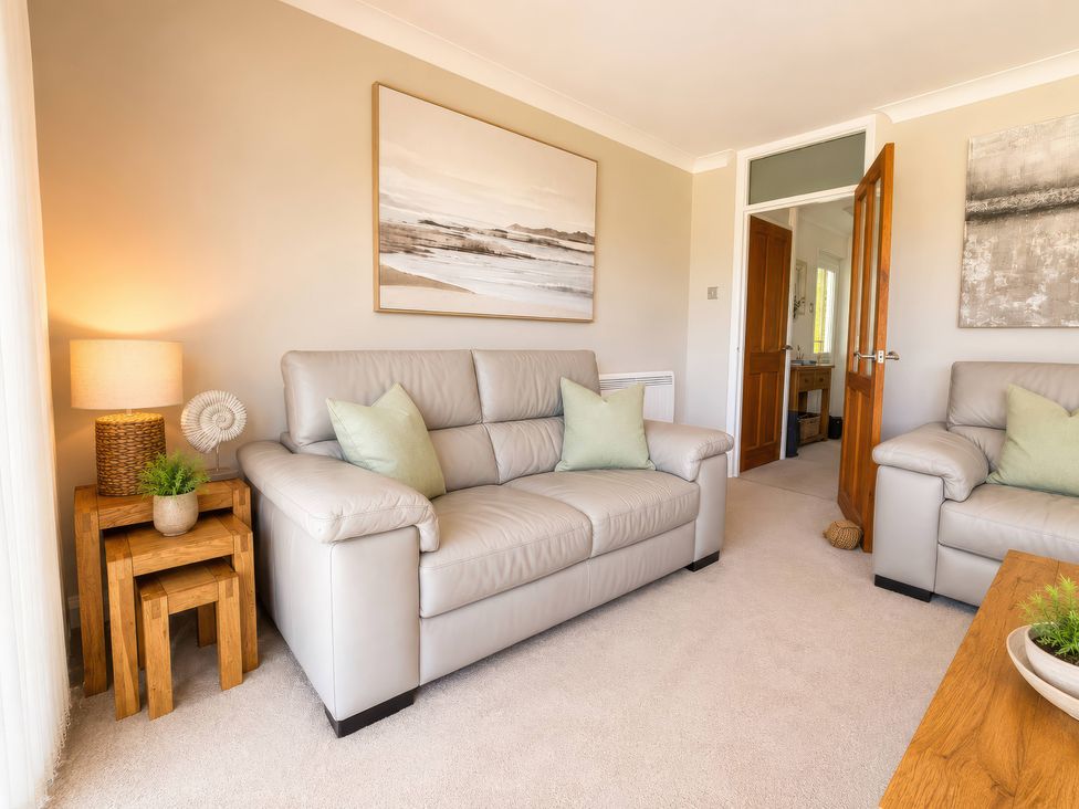 A living room with two sofas and a side table at 6 Coedrath Park - Swn y Mor in Saundersfoot