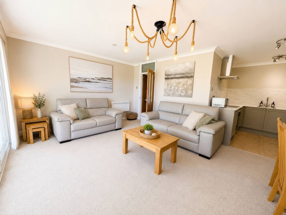 A living room with sofas and a coffee table at 6 Coedrath Park - Swn y Mor Saundersfoot