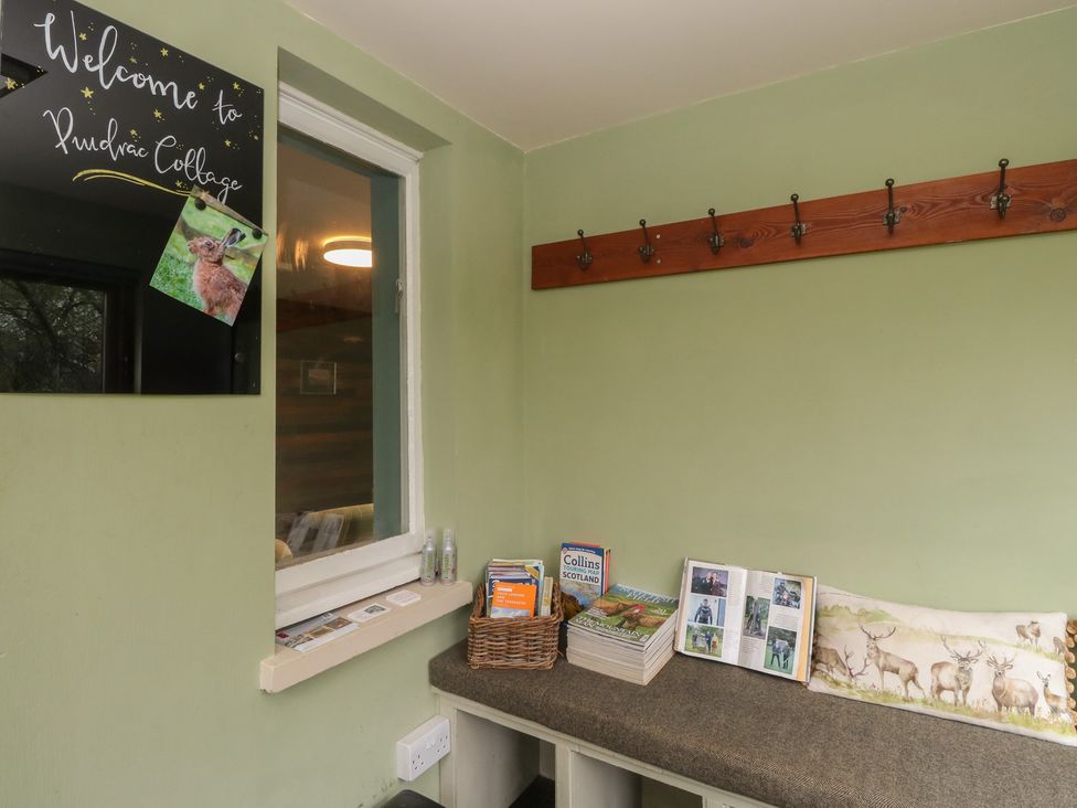 A welcome area with hooks and brochures at Puidrac Cottage in Balquhidder