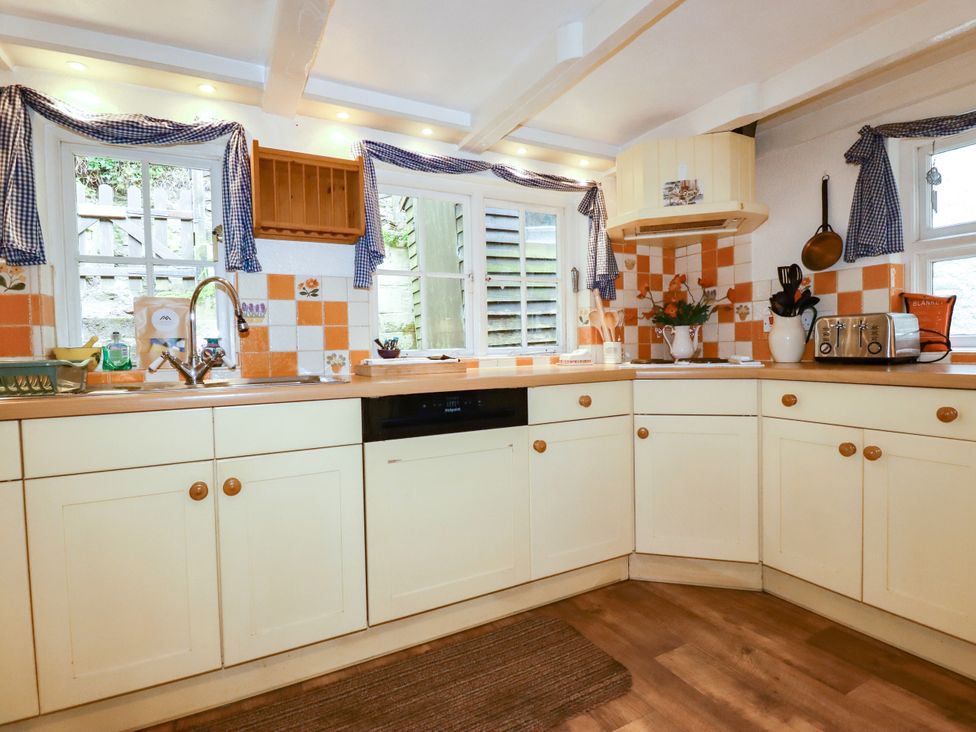 A kitchen with cabinets and a sink at Vi’s Valley View in Pentewan